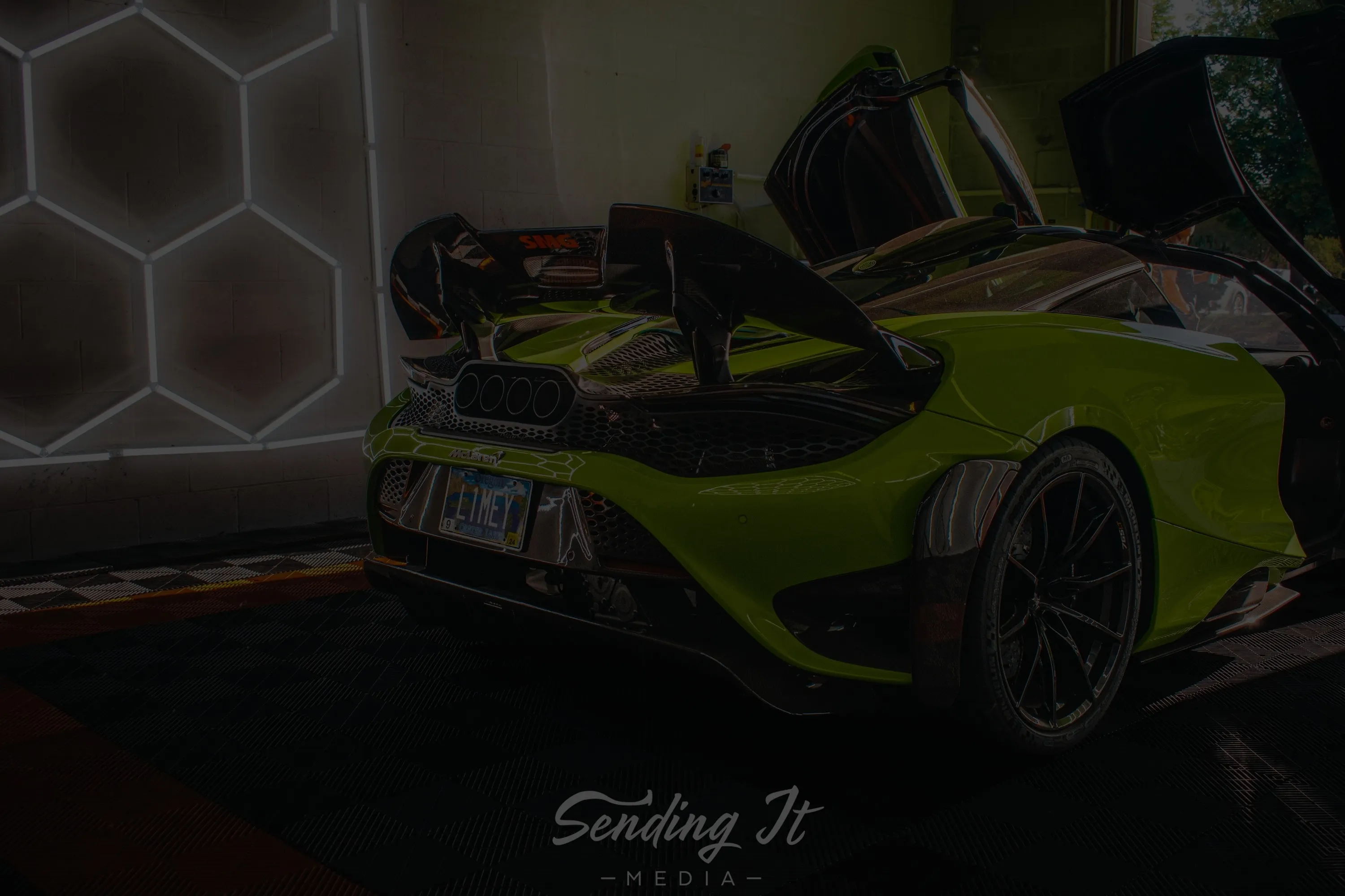 Lime green McLaren with doors up