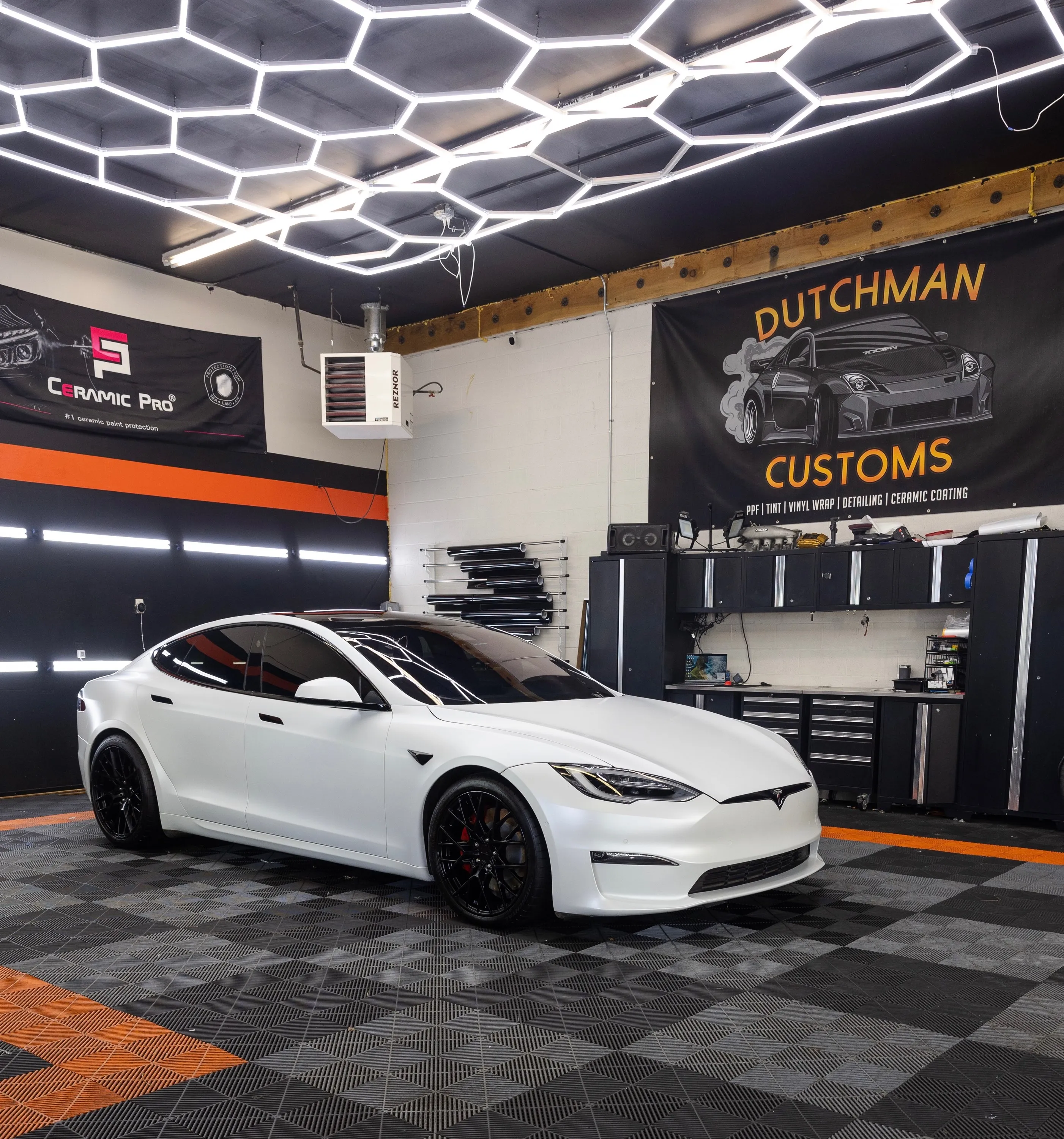 White Tesla Model S Plaid, side view in the bay