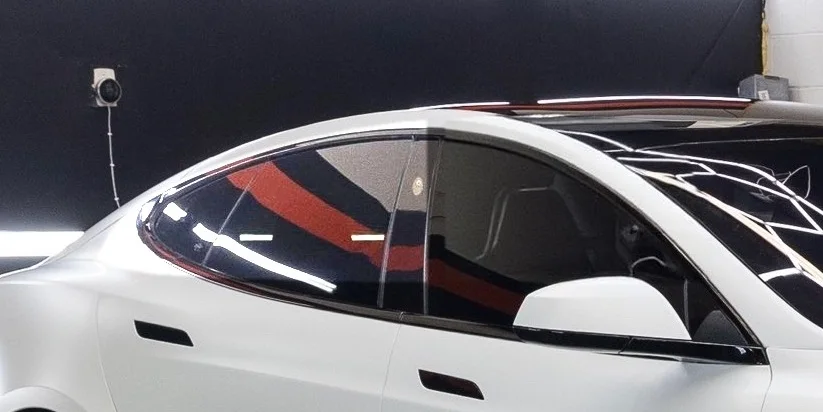 White Tesla Model S in the bay, side glass shown at the tint shade you picked